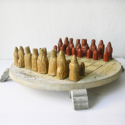 A chess set made of stone with cared pieces